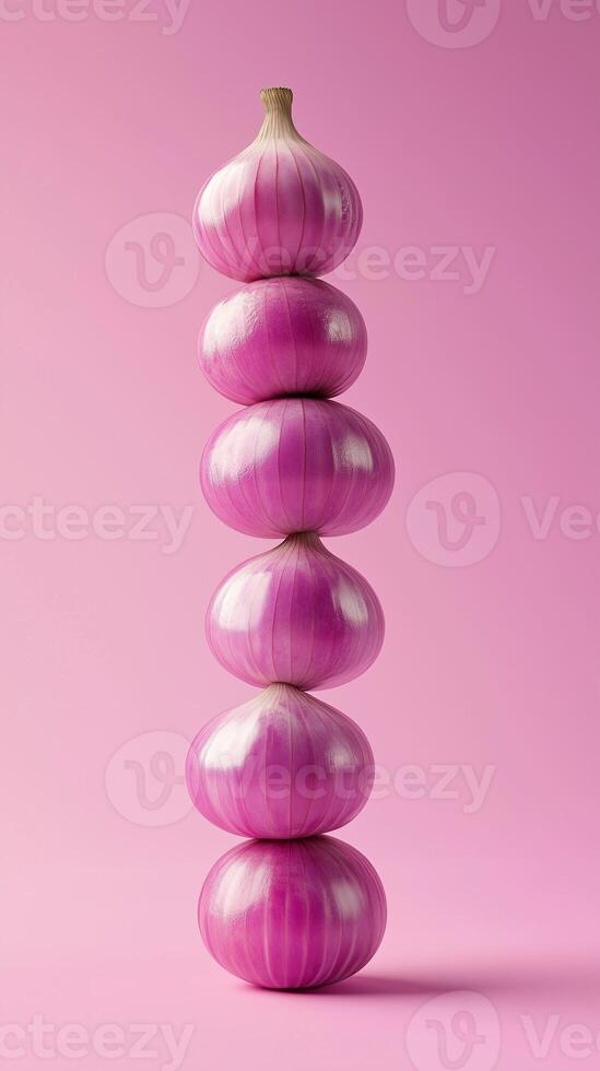 A stack of red onion balancing to top with solid bacground photo
