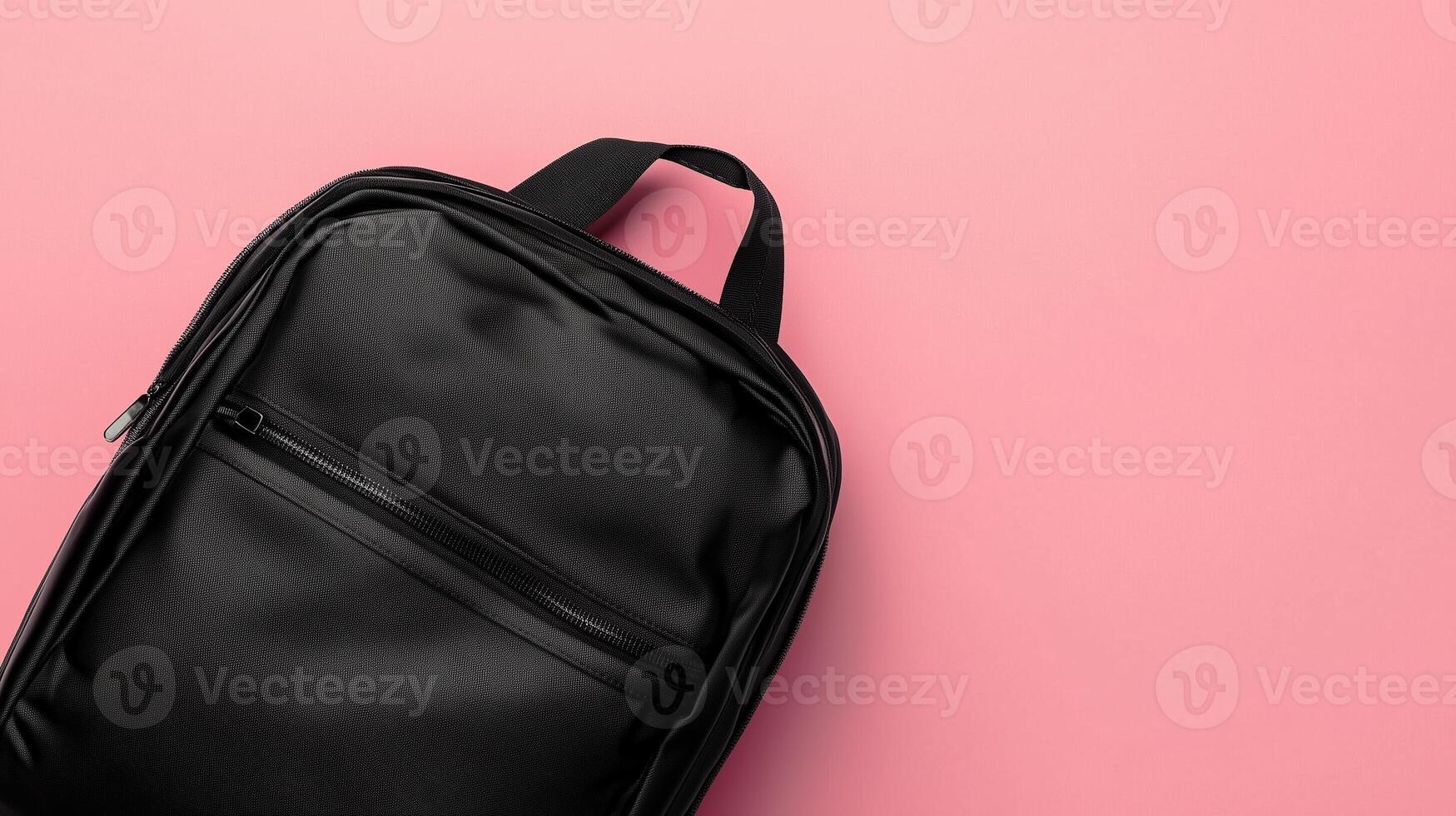 Black school bag a stationery place or working briefcase copy space pink background photo