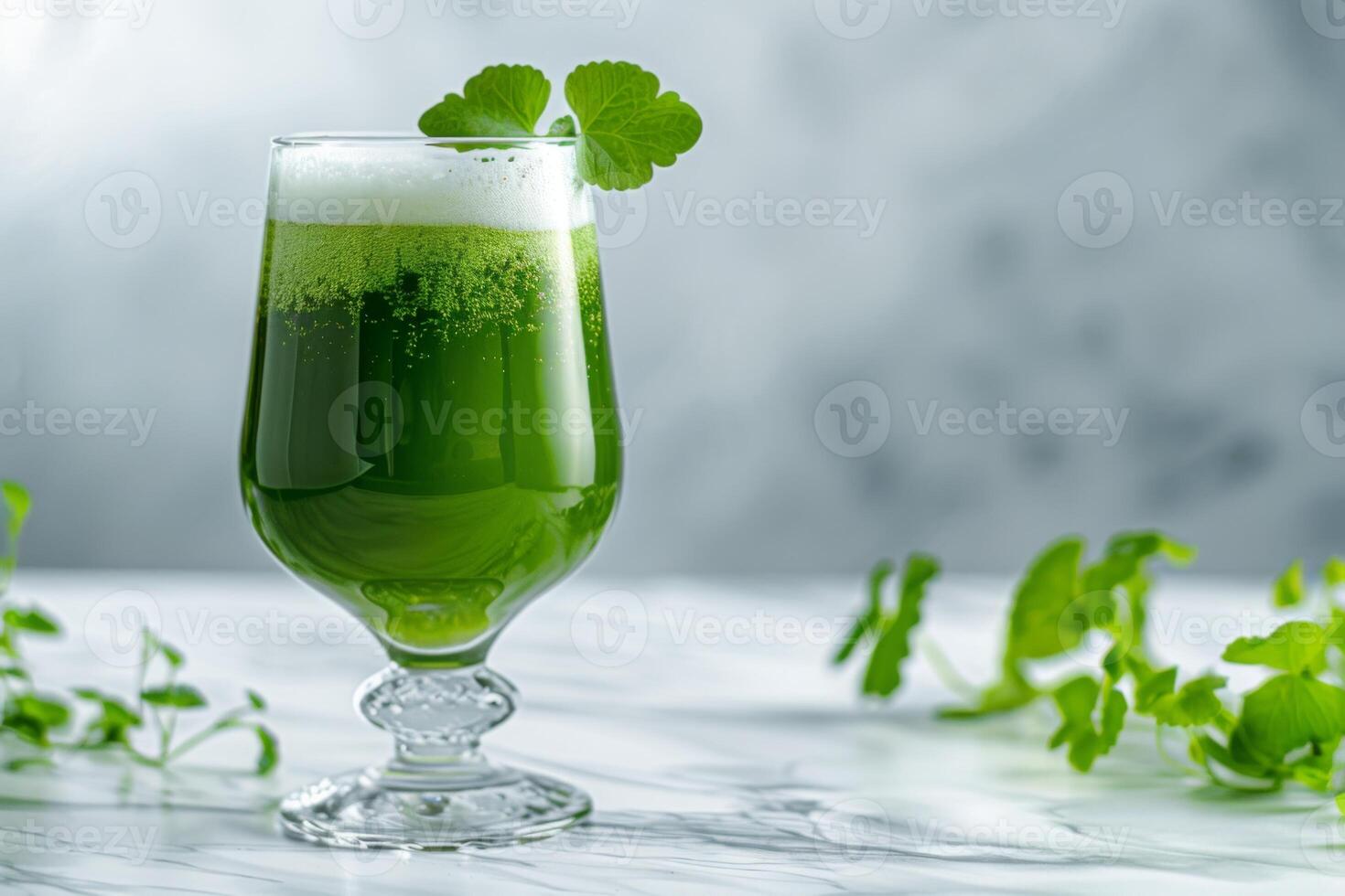 A glass of green liquid photo