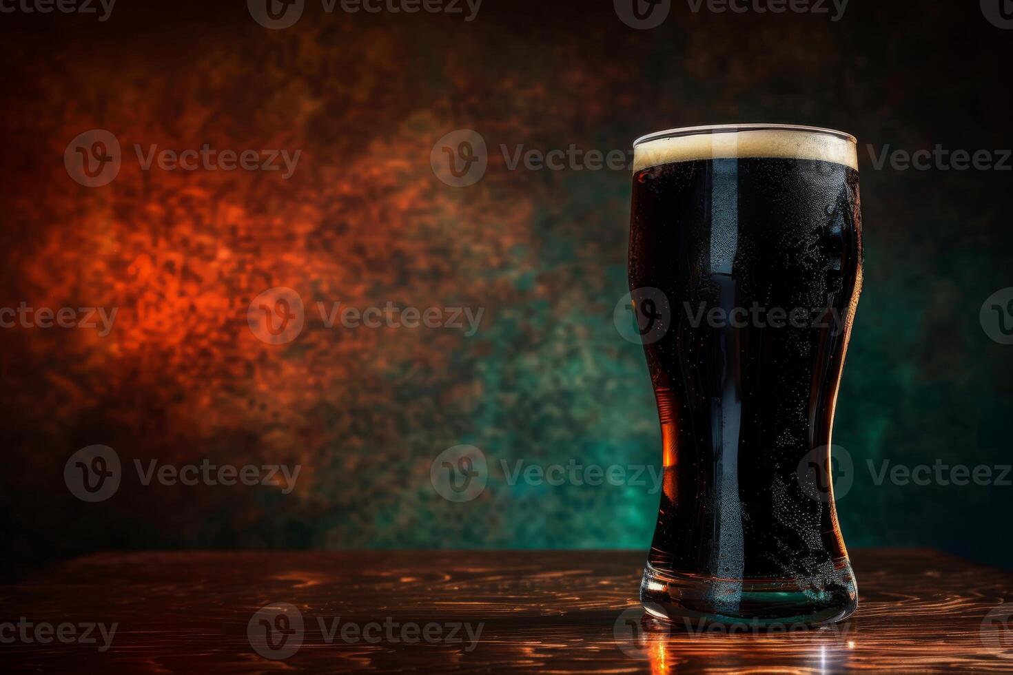 A glass of dark beer on a table photo