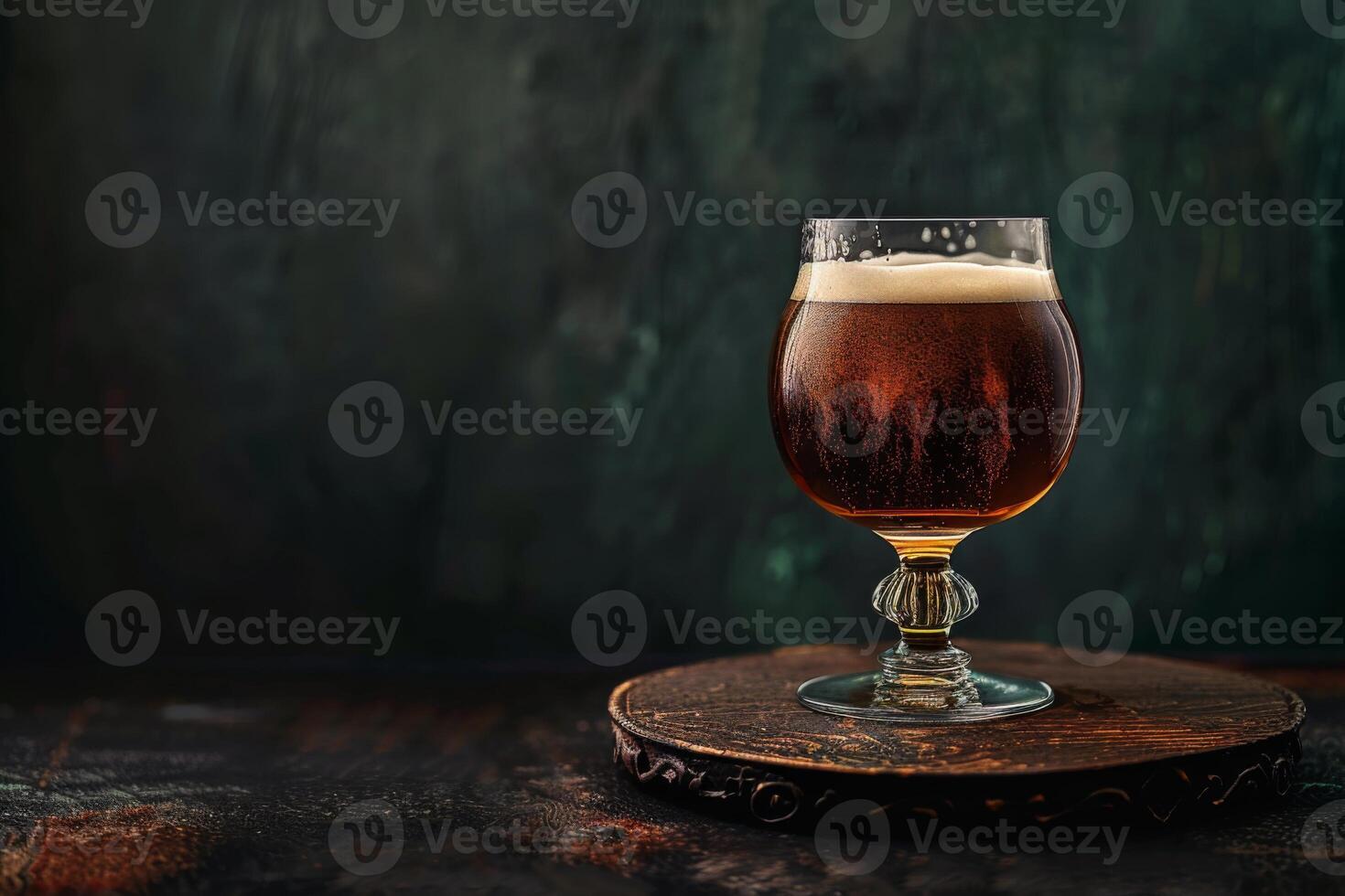 A glass of beer on a wooden table photo