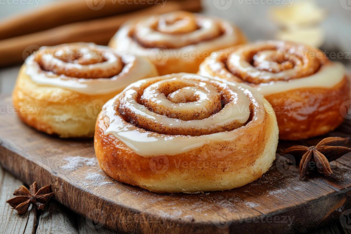 Cinnamon rolls on a wooden board with cinnamon and anise photo