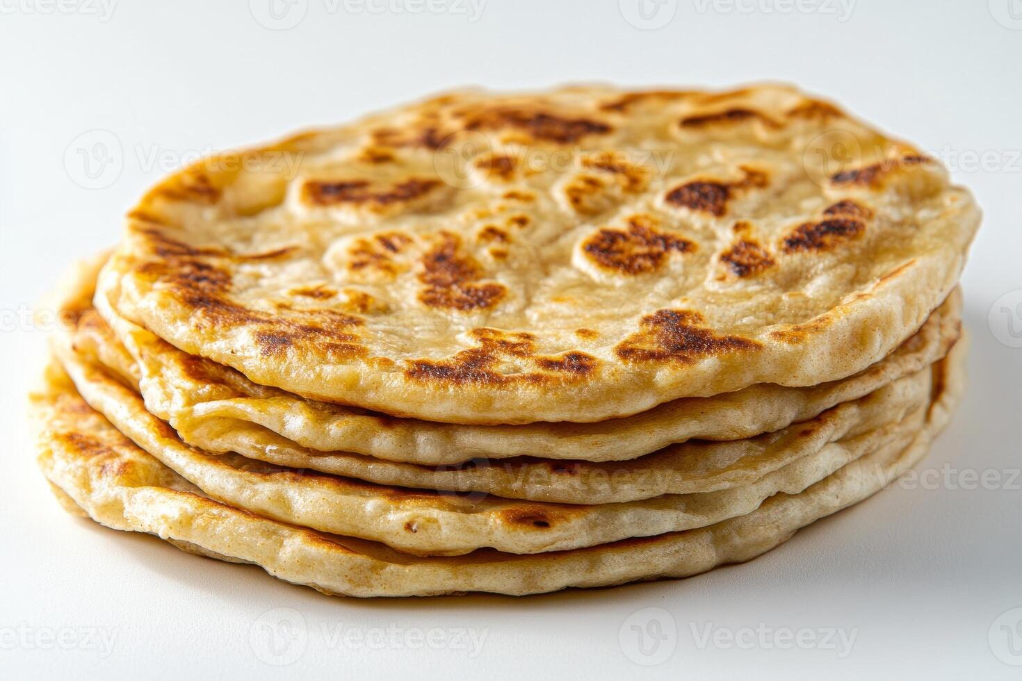 A stack of flatbreads on a white surface photo