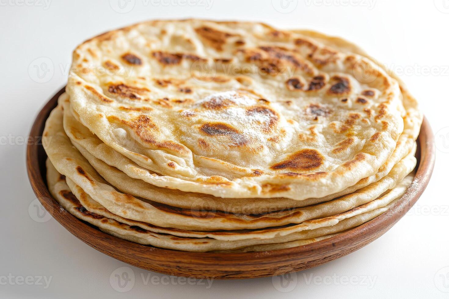 A bowl of flatbreads on a white surface photo