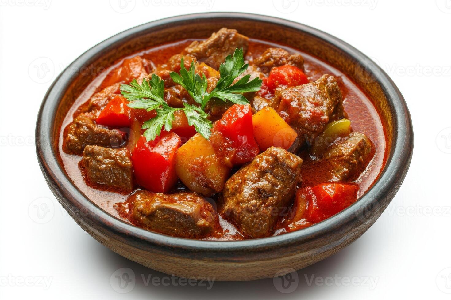 A bowl of beef stew with vegetables and parsley photo
