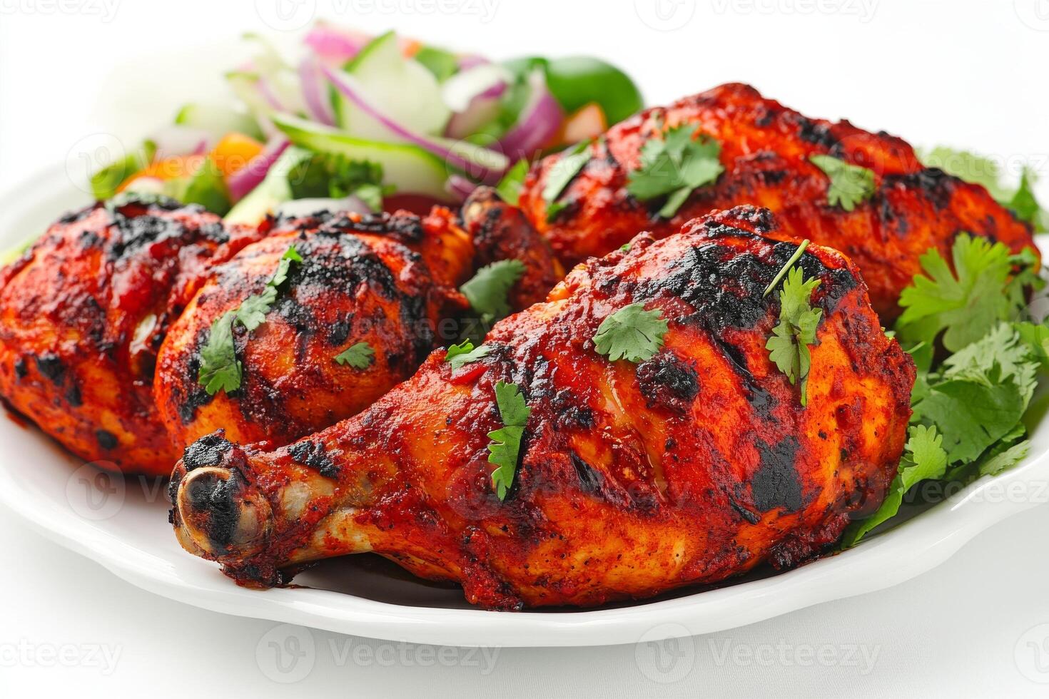 A plate of chicken wings with vegetables and a salad photo