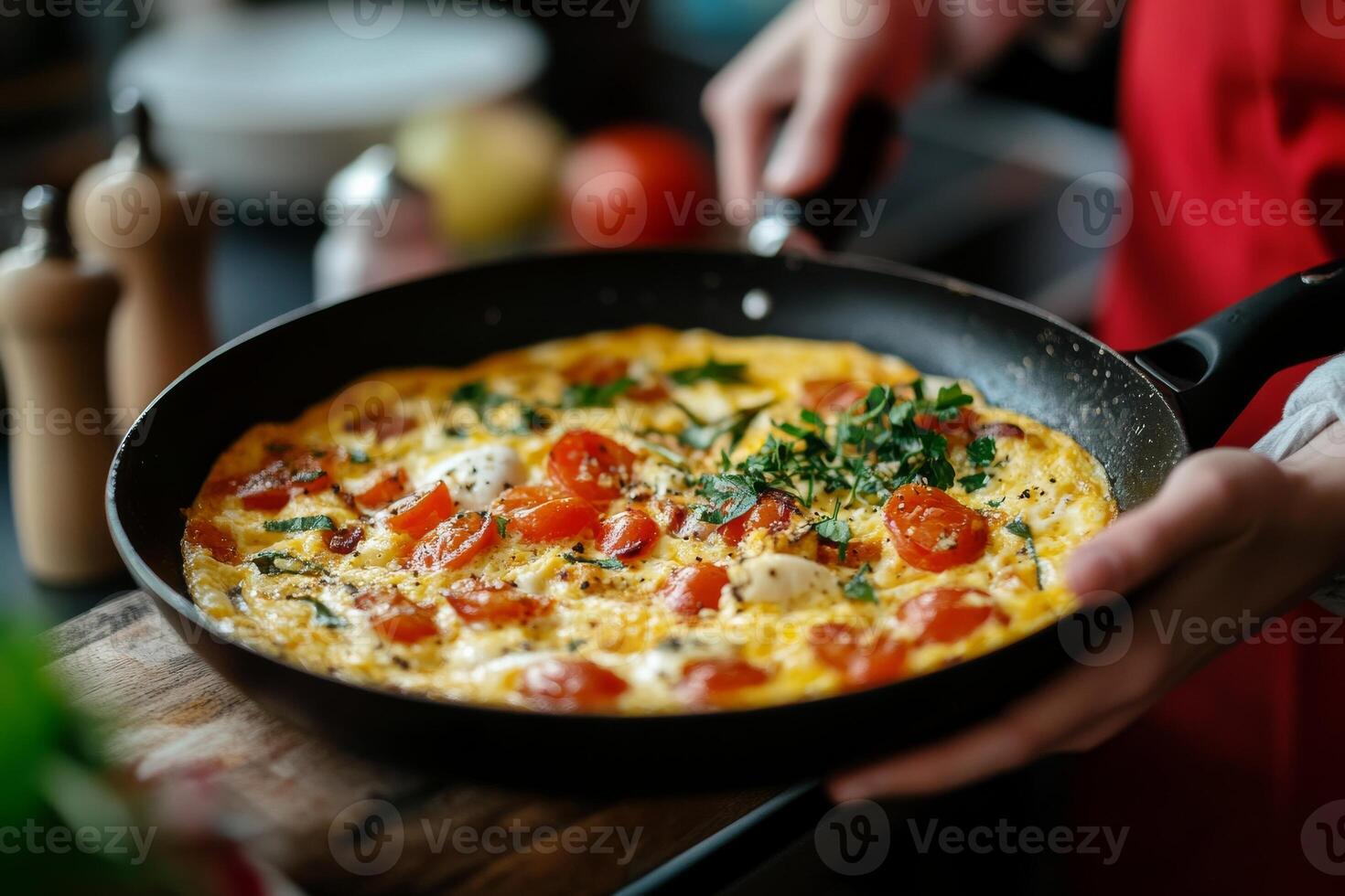 A person holding a pan with an omelet in it photo