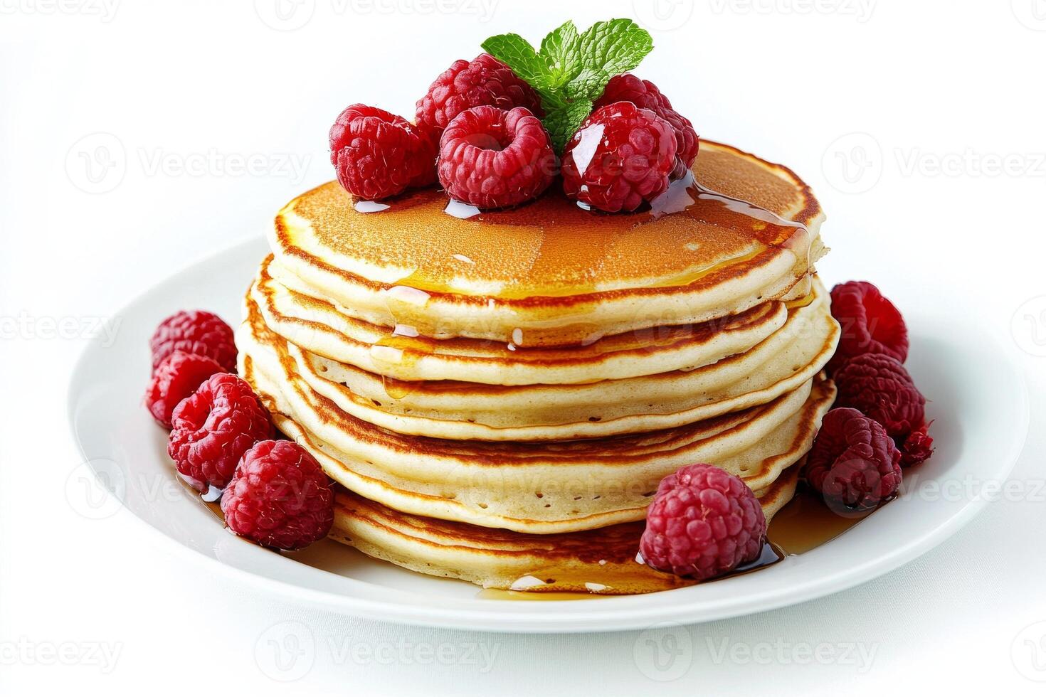 A stack of pancakes with raspberries and mint photo