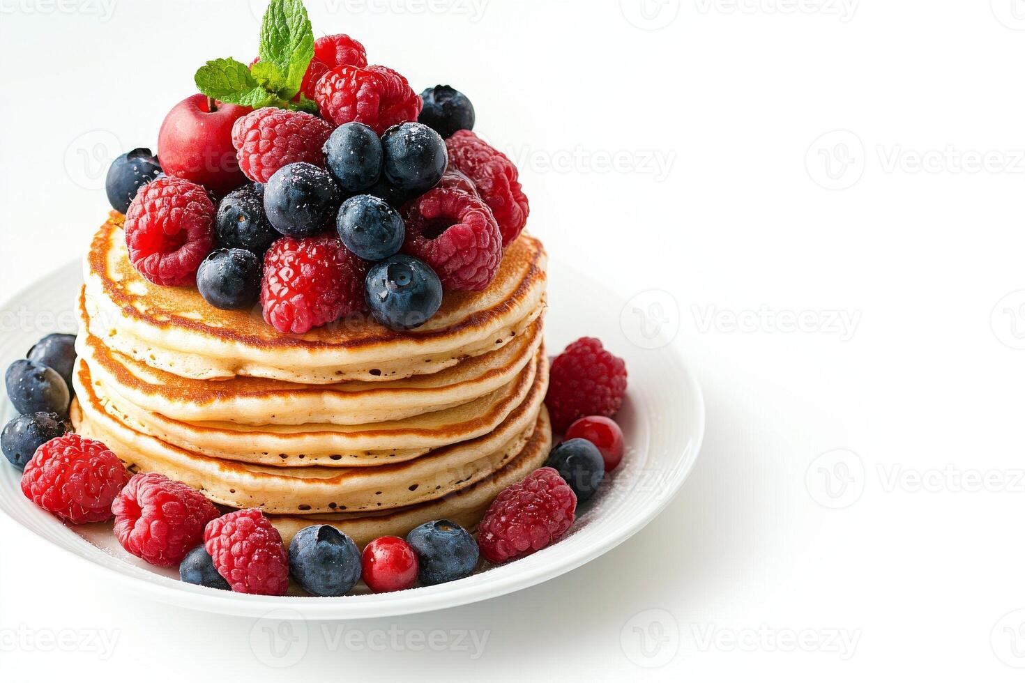 A stack of pancakes with berries on top photo