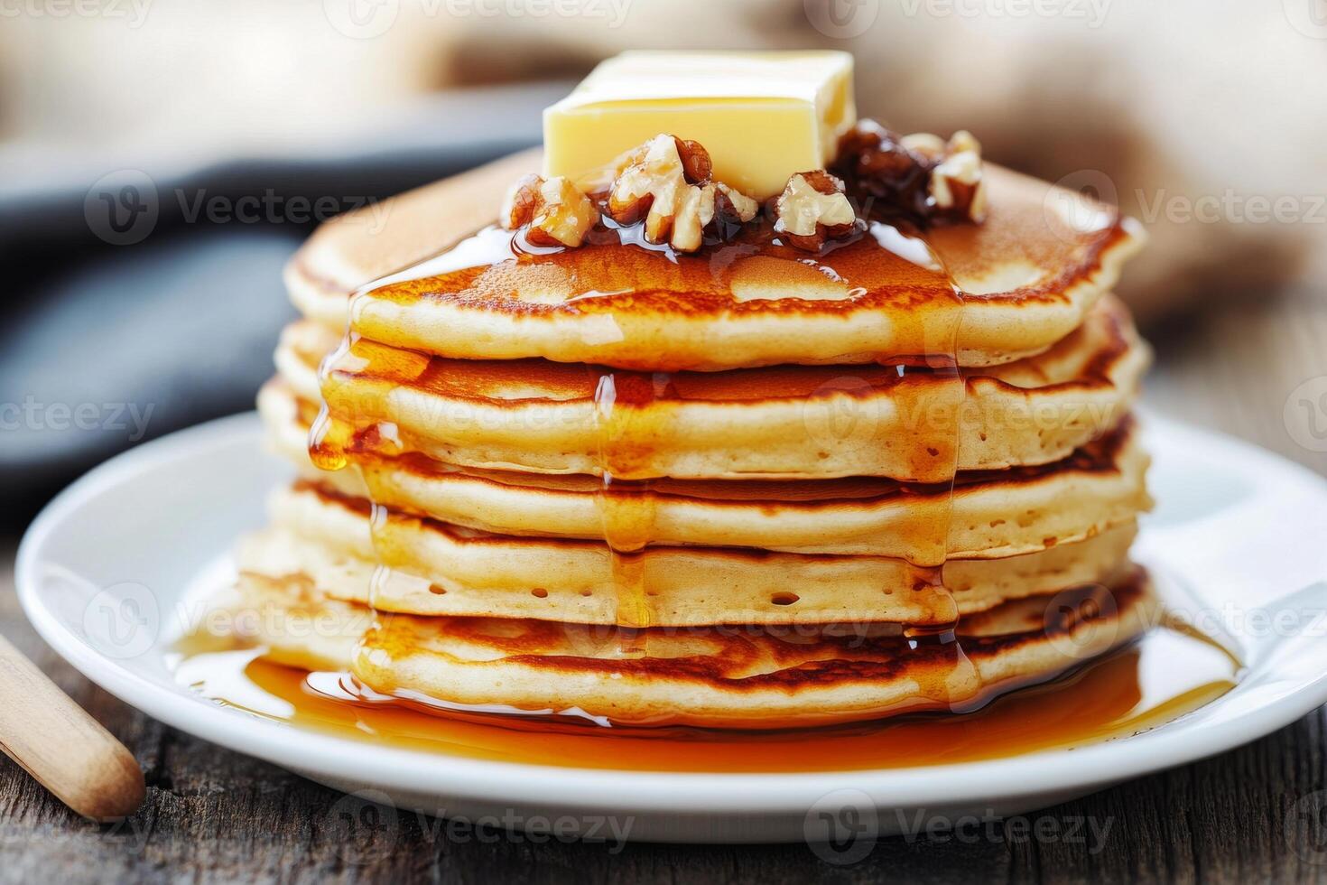 A stack of pancakes with syrup and butter photo