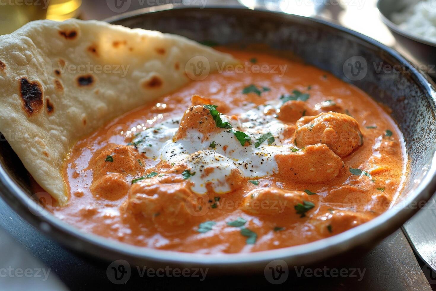 A bowl of curry with a pita bread photo