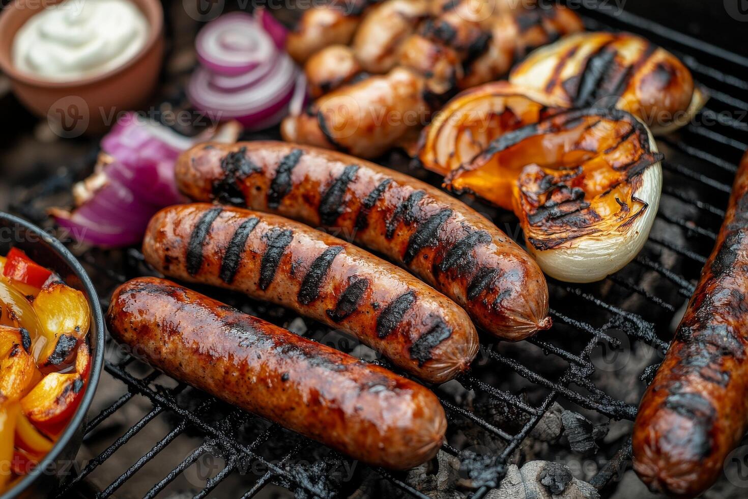 Grilled sausages and vegetables on a grill photo
