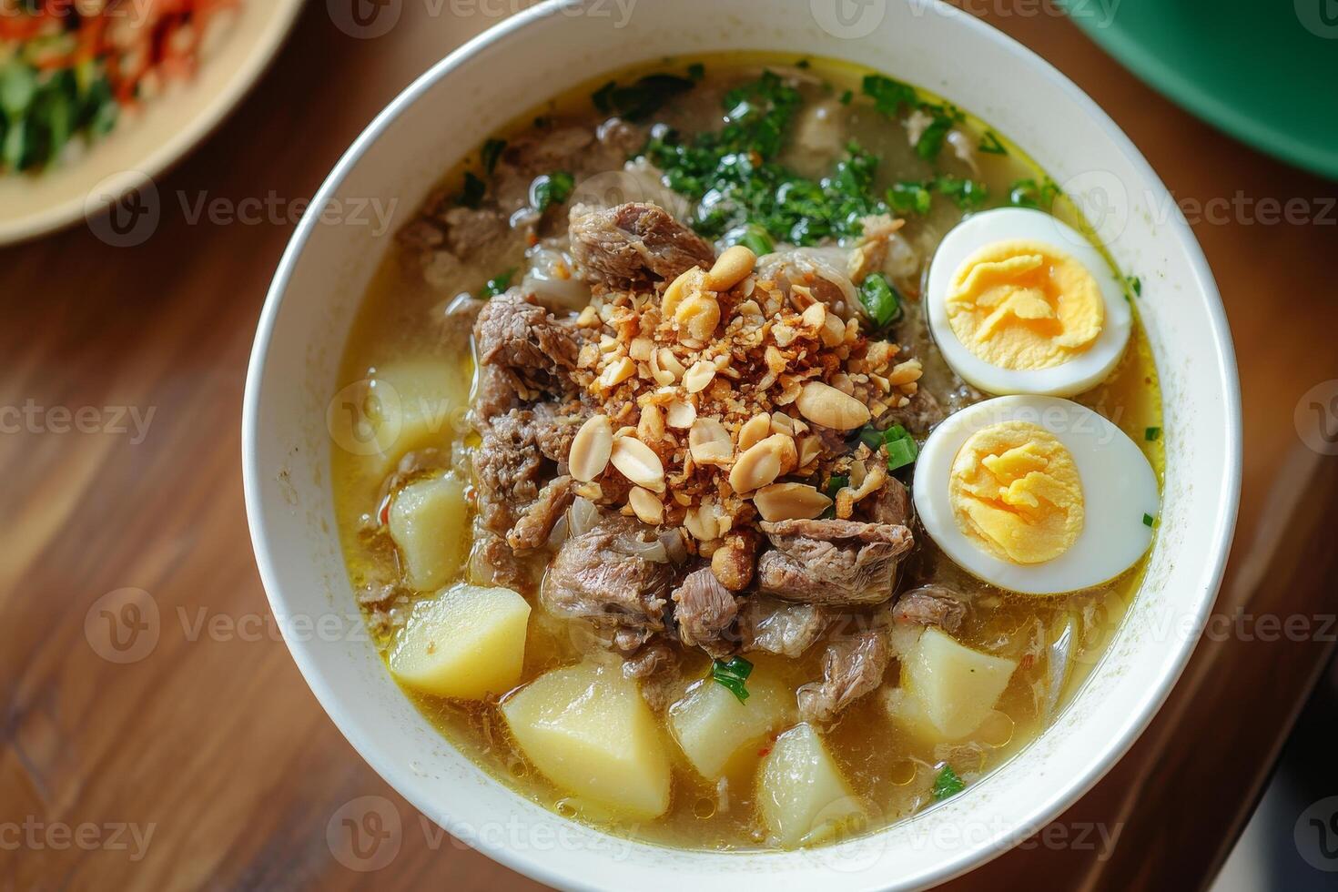 A bowl of soup with meat, eggs and vegetables photo