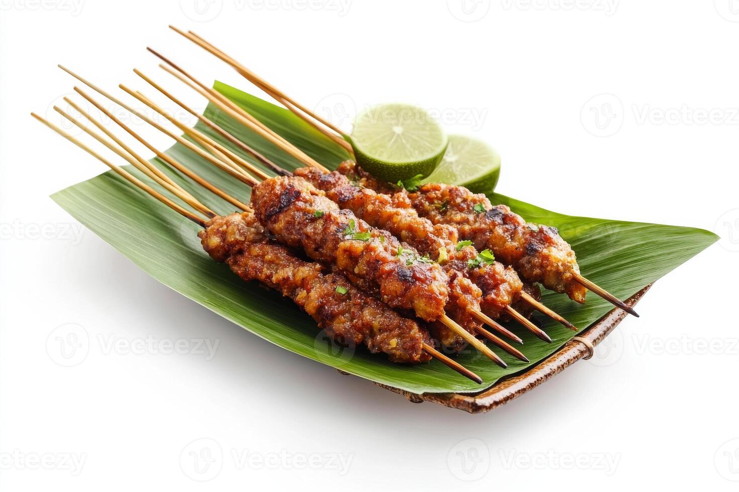 A plate with several skewers of meat on a leaf photo