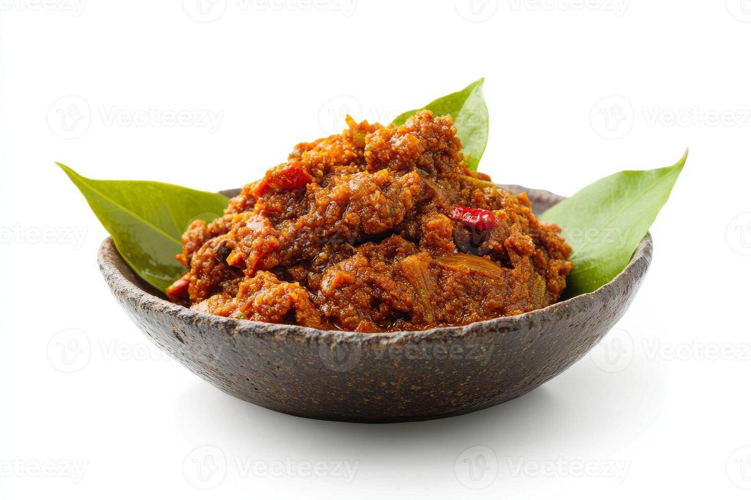 A bowl of curry with a leaf on top photo