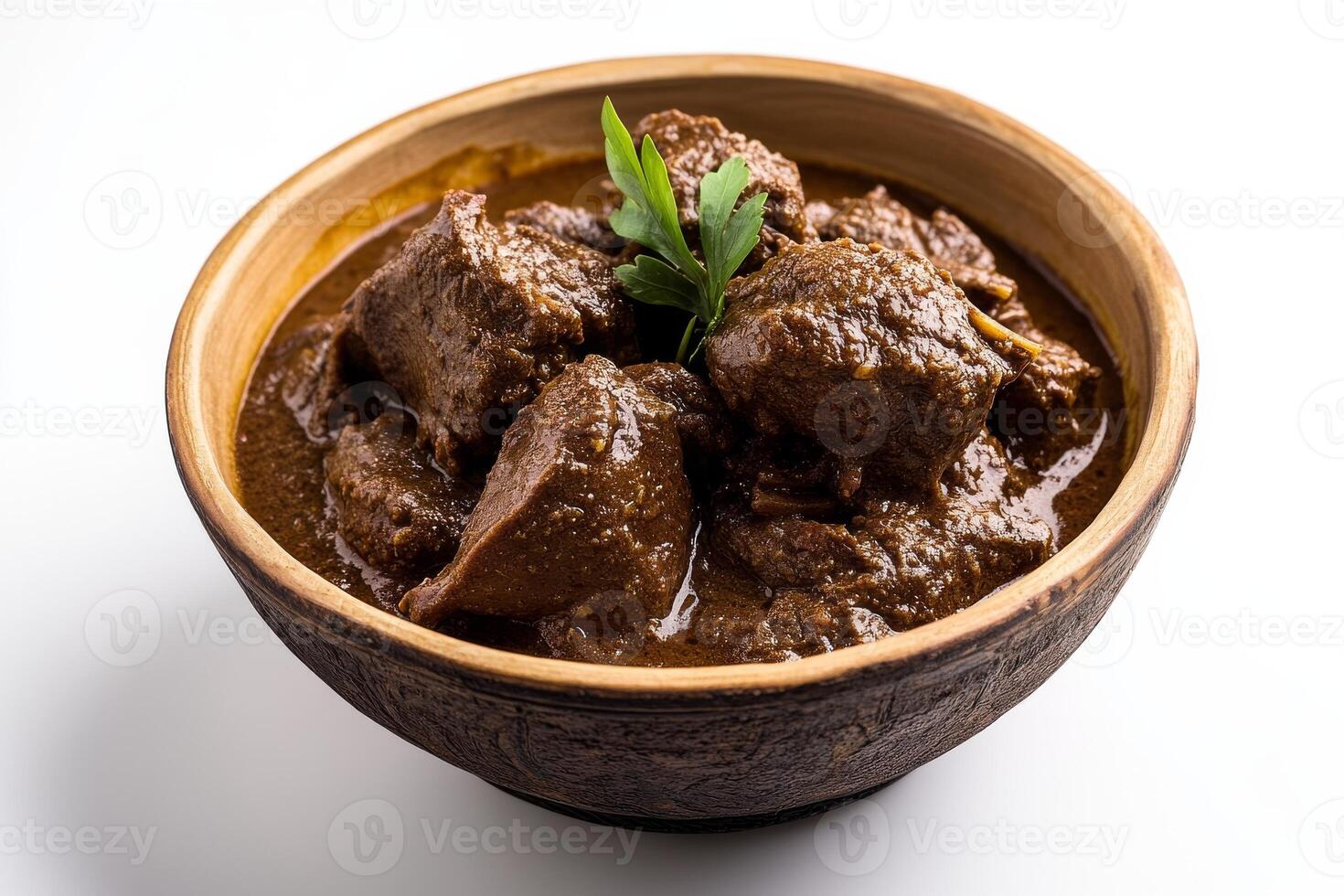 A bowl of beef stew with a sprig of herbs photo