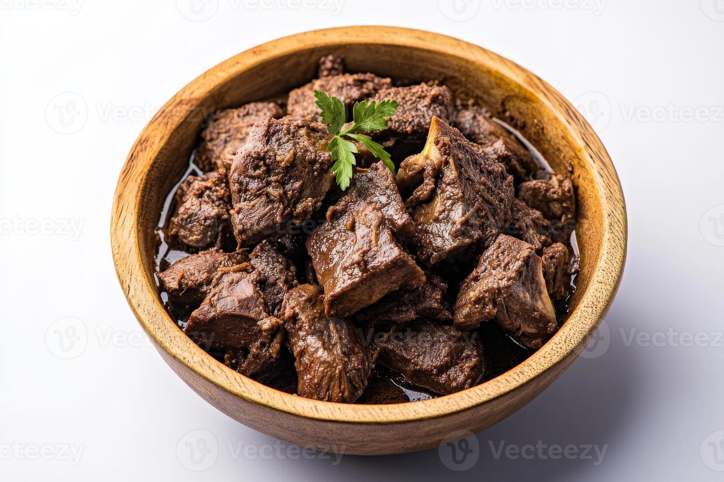 A bowl of beef with parsley on top photo