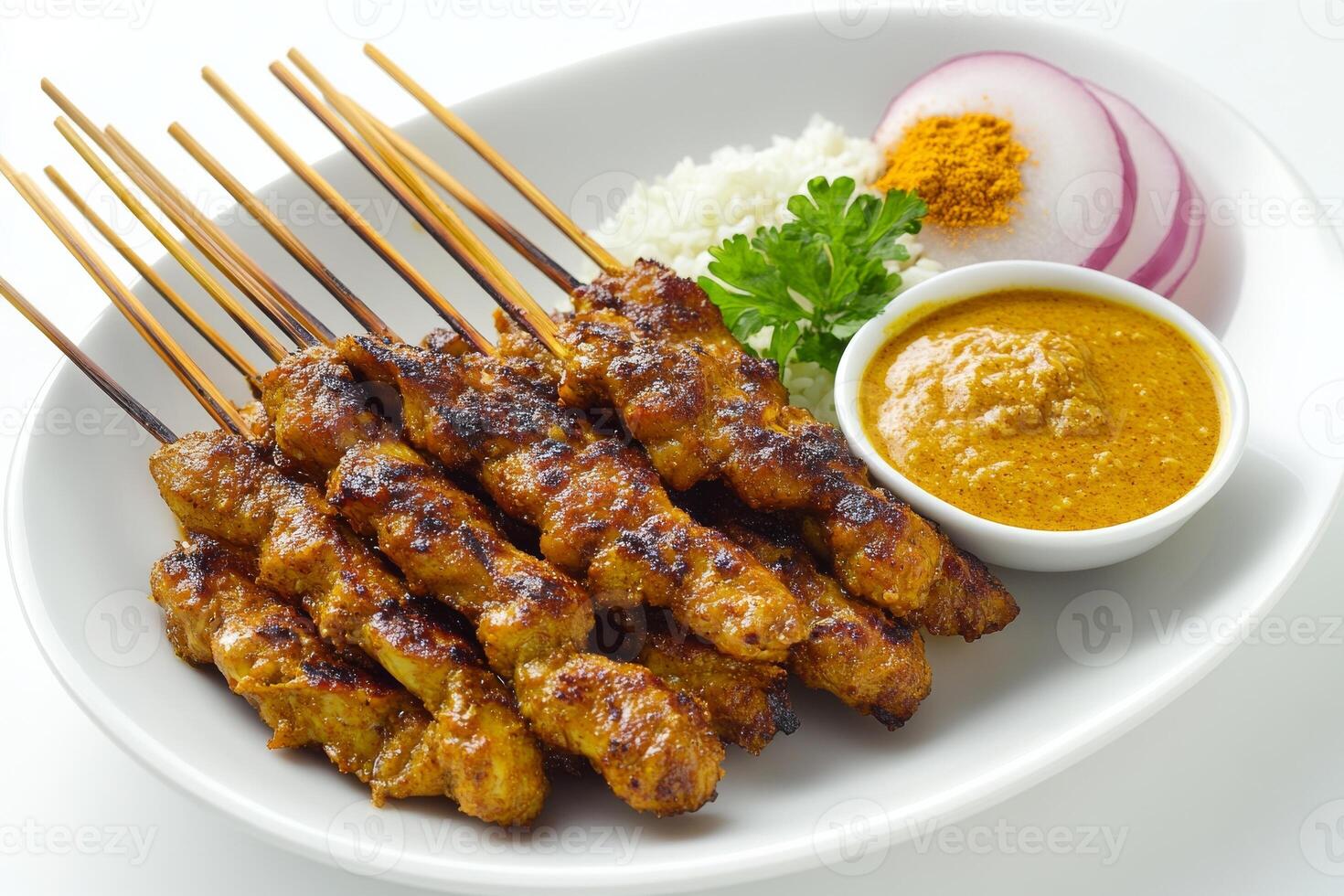 A plate with chicken satay skewers and rice photo