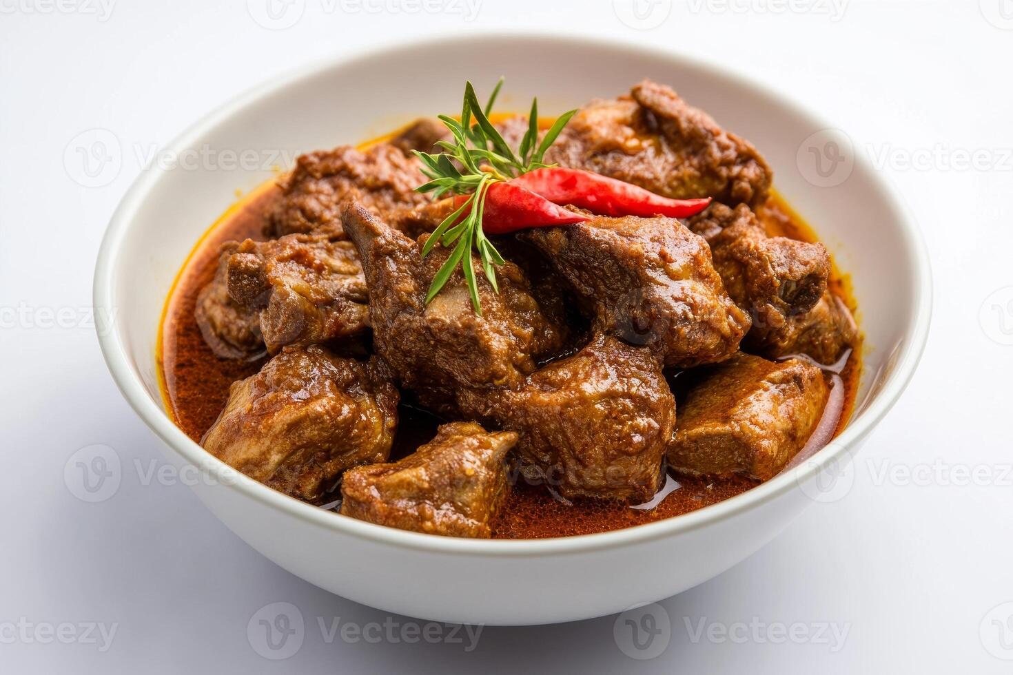 A bowl of meat and spices on a white table photo