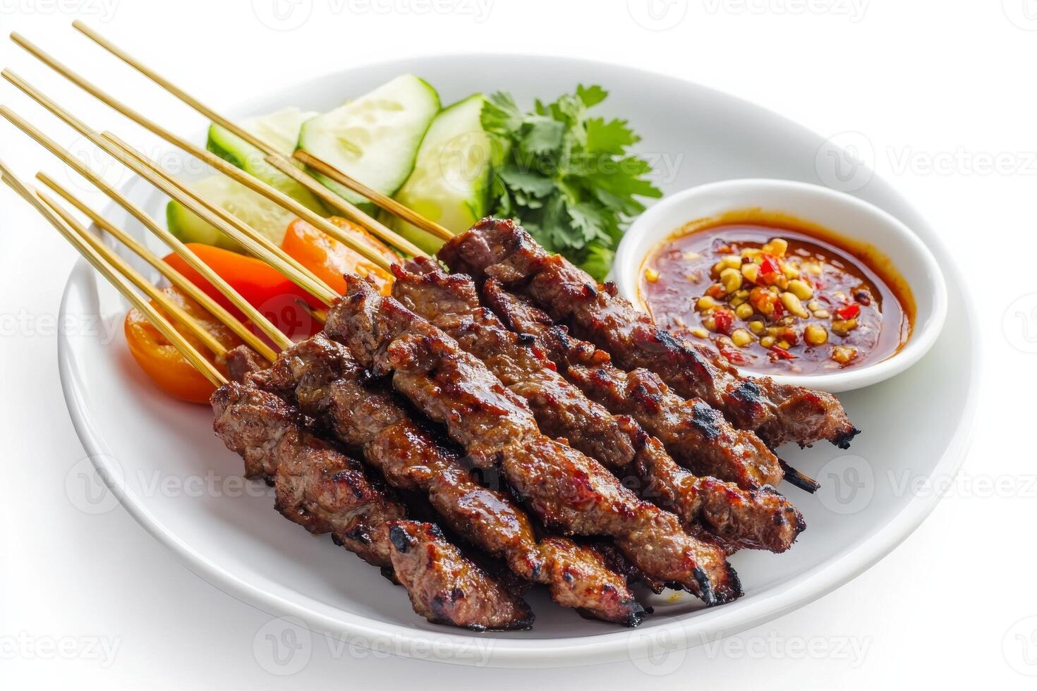Thai beef satay on a white plate with sauce photo