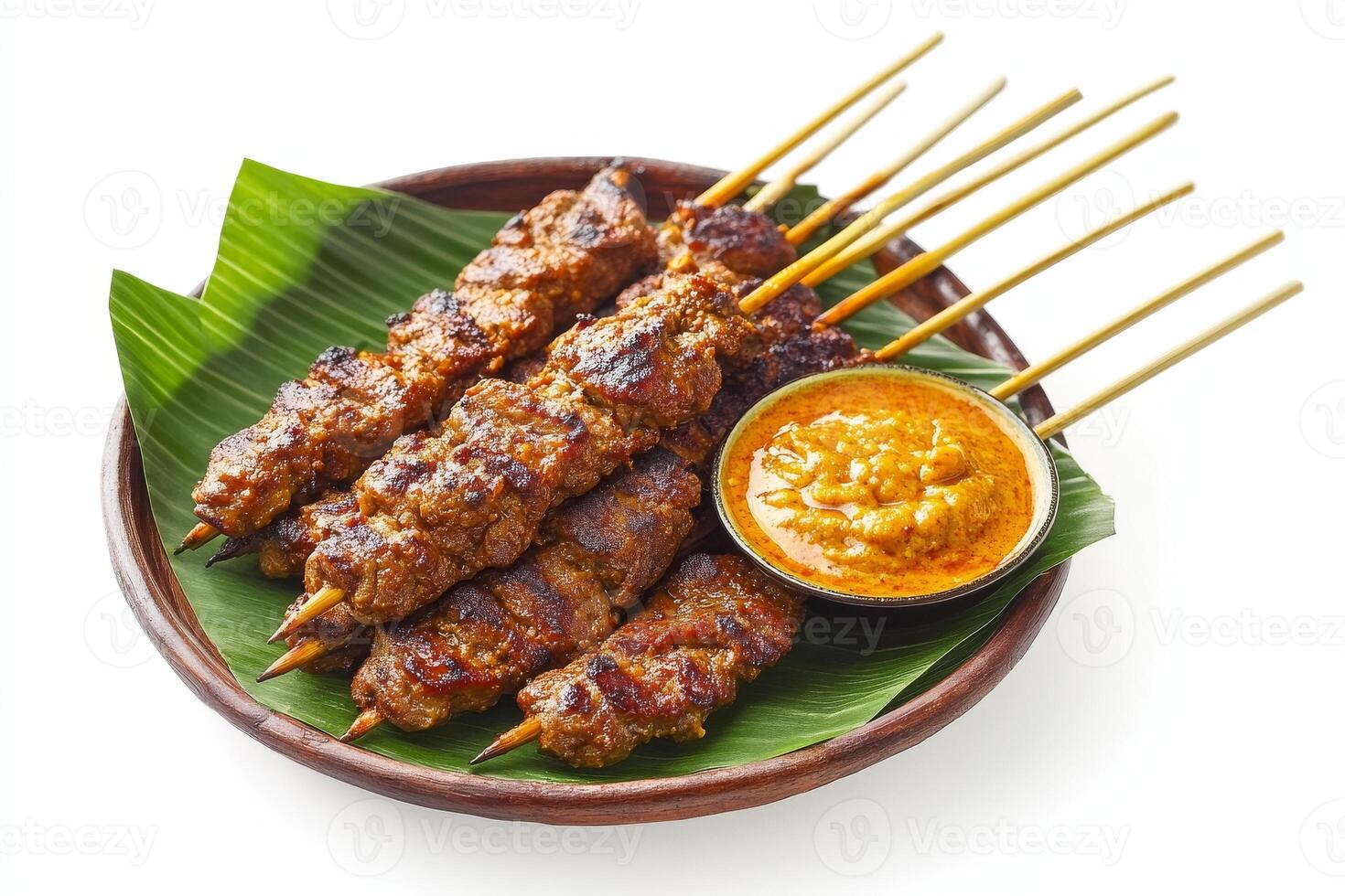 A plate with skewers of meat and sauce photo