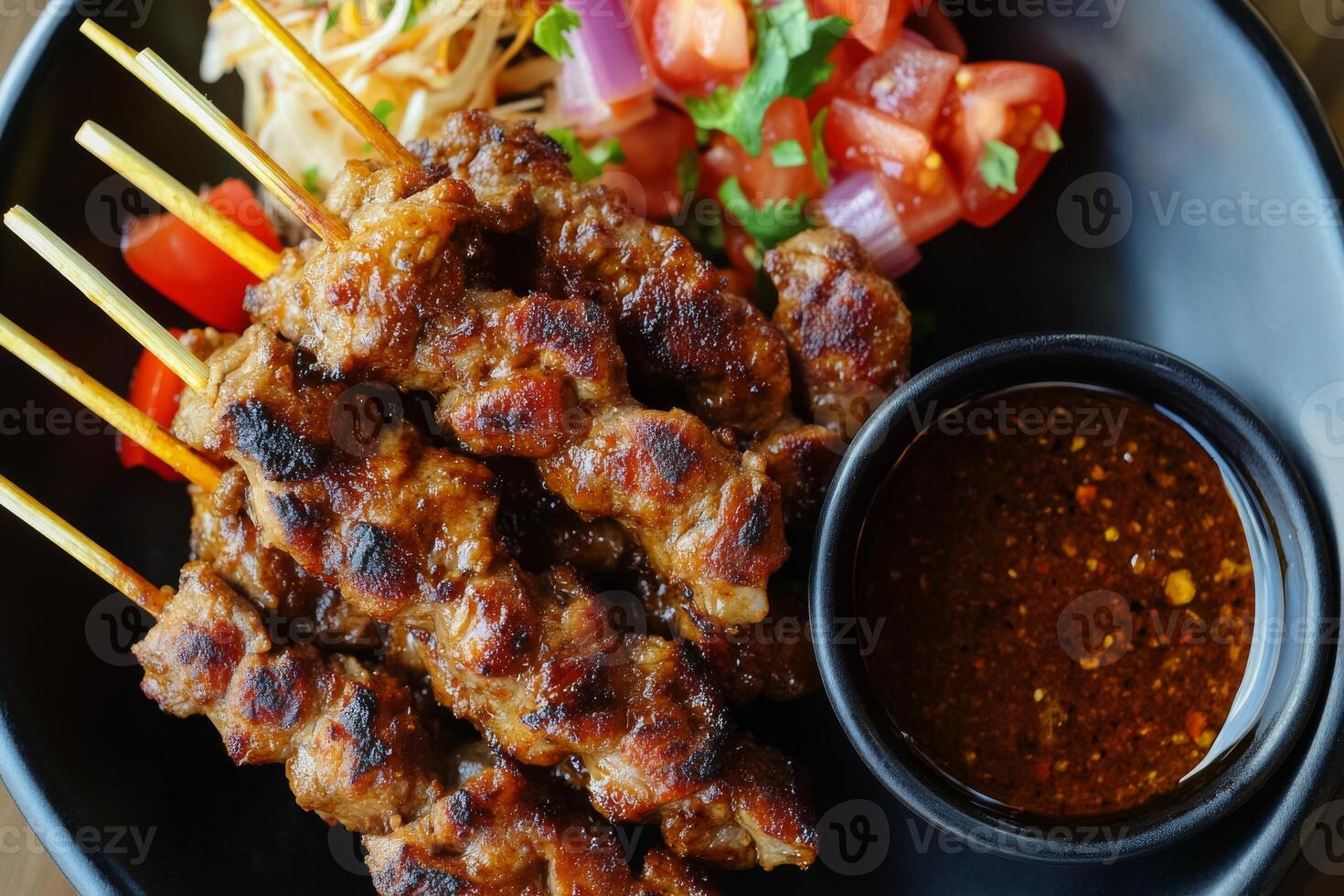 A plate with meat skewers and sauce photo