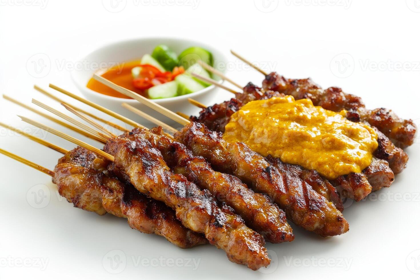 A plate with several skewers of meat and sauce photo