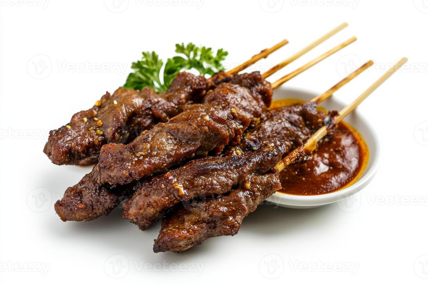 A plate of meat skewers with sauce on them photo