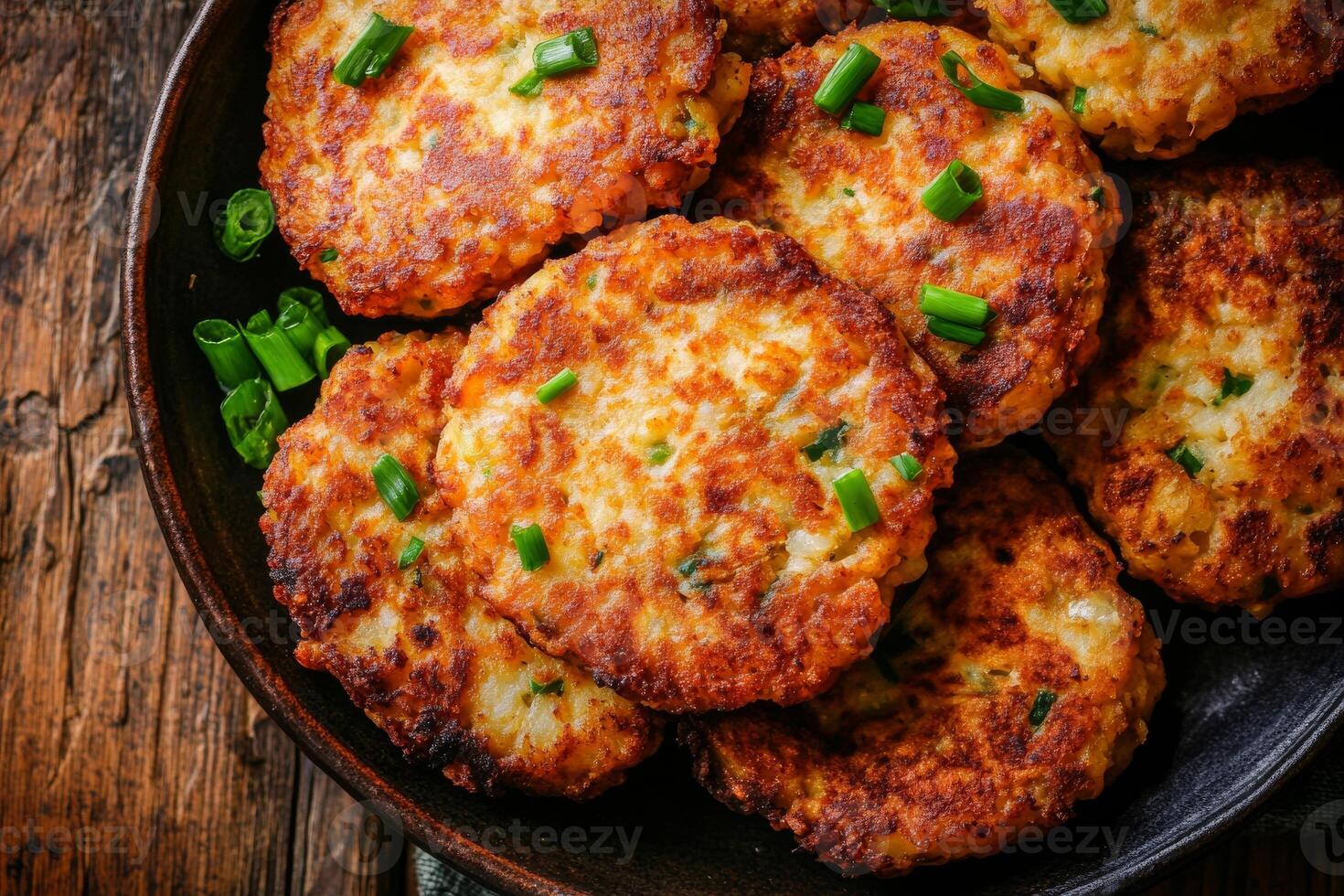 A plate of fried potato cakes with green onions photo