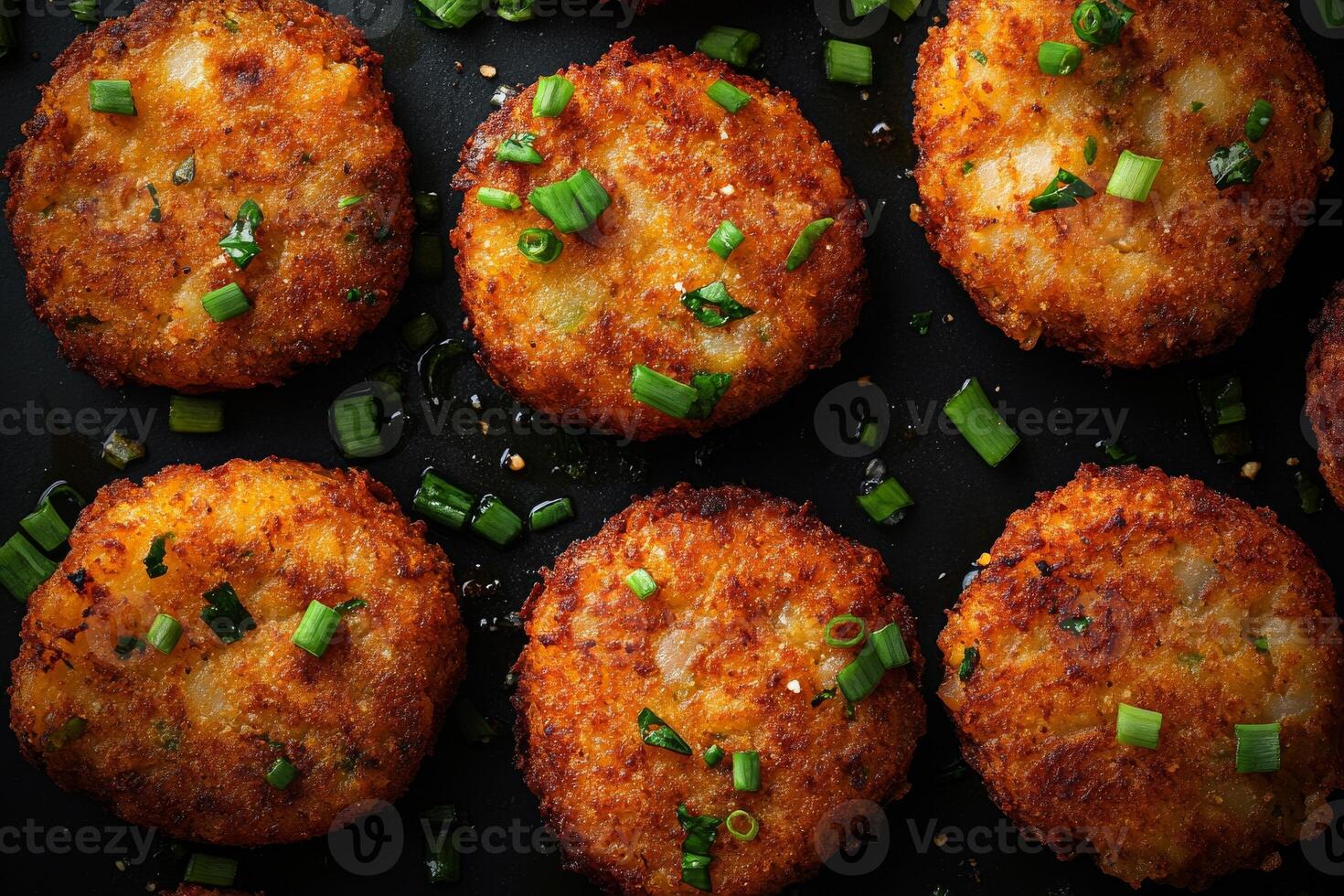 A group of fried potato cakes with green onions photo