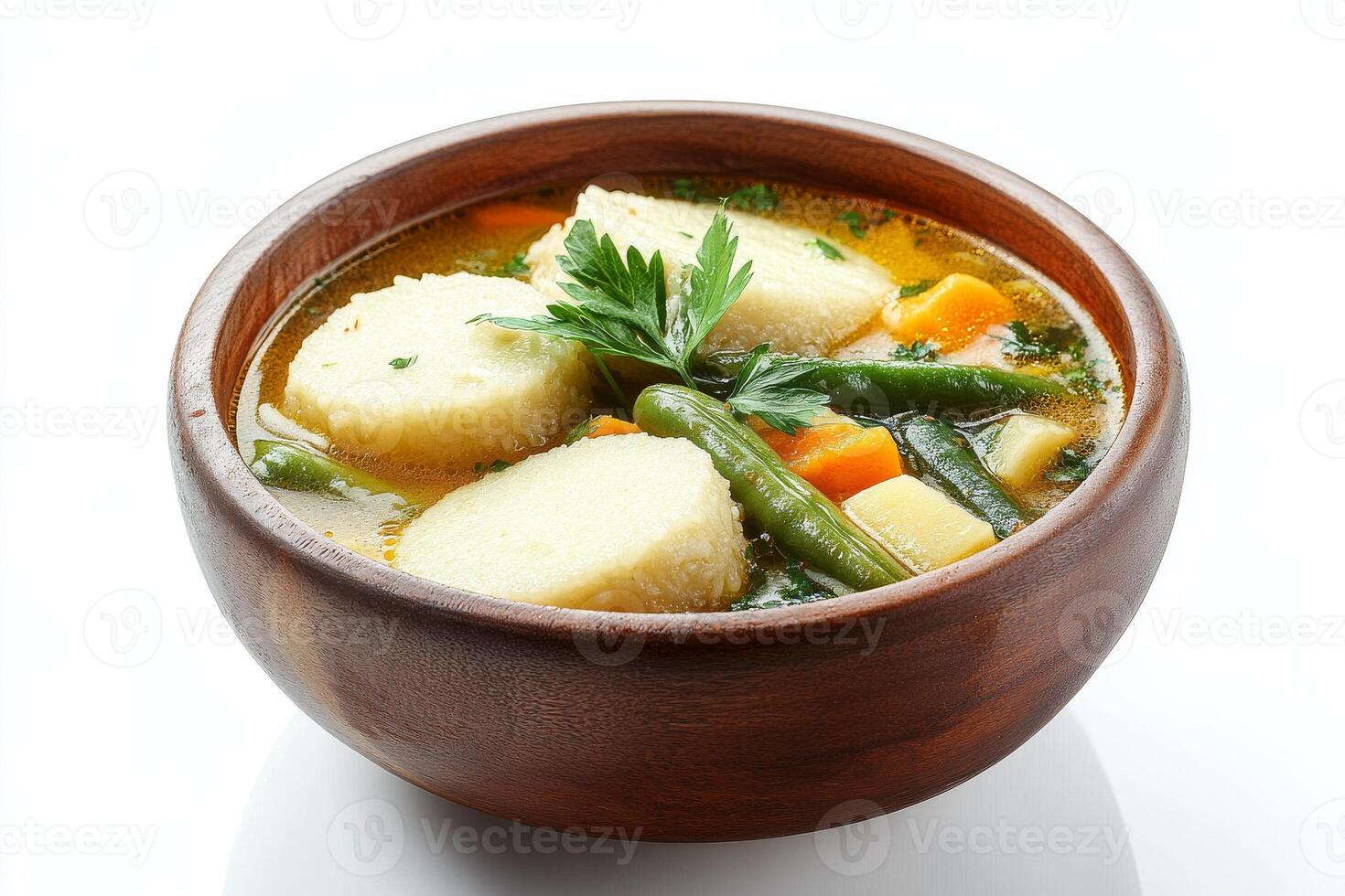 A bowl of soup with dumplings and vegetables photo