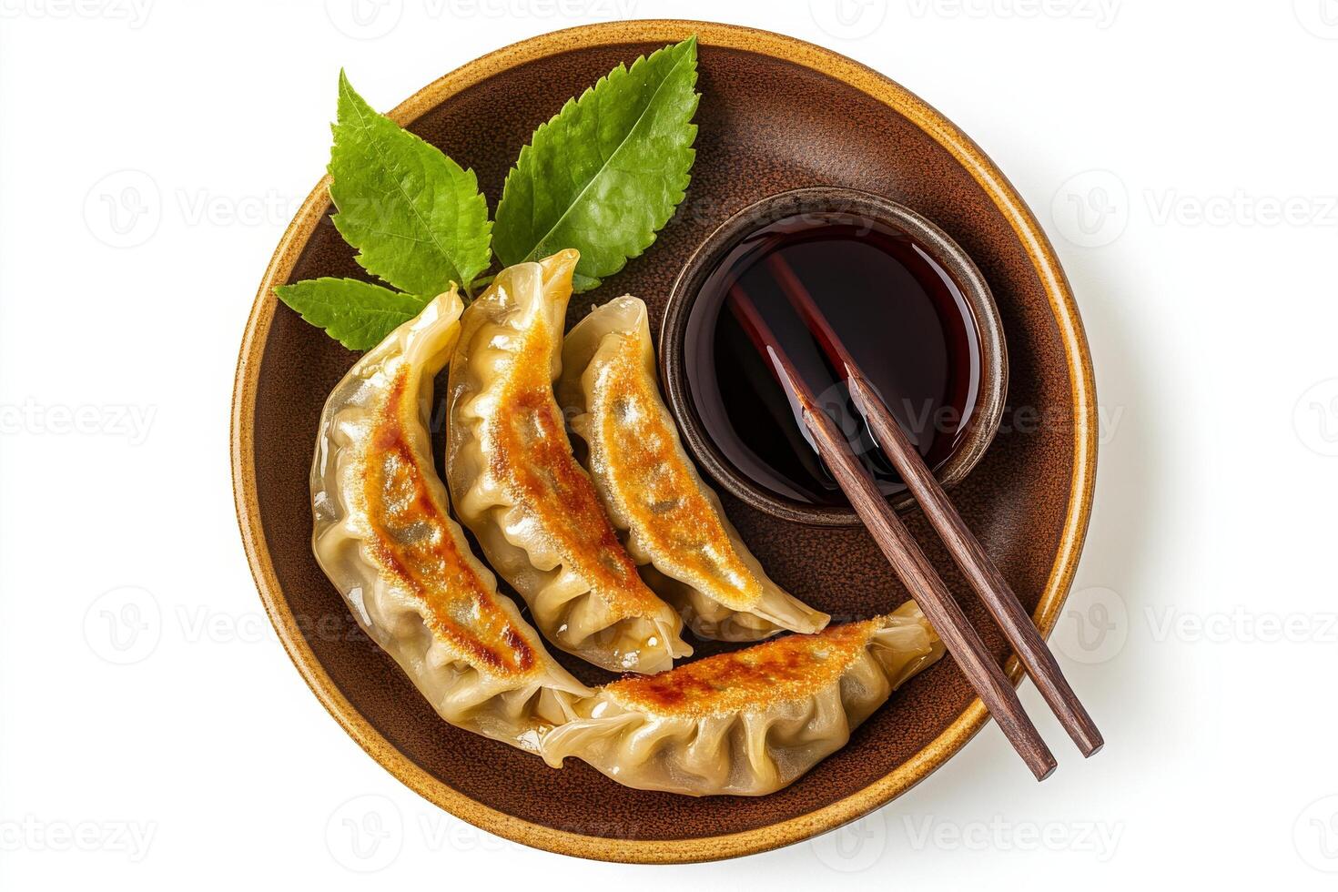 Chinese dumplings with sauce and chopsticks on a plate photo