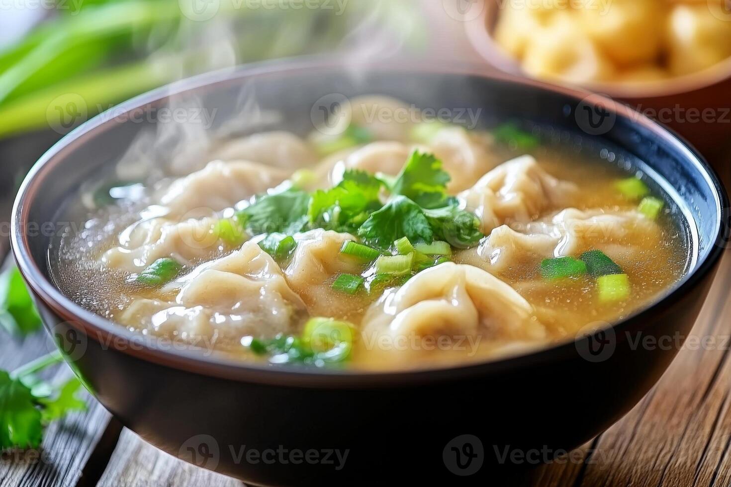 A bowl of soup with dumplings and vegetables photo