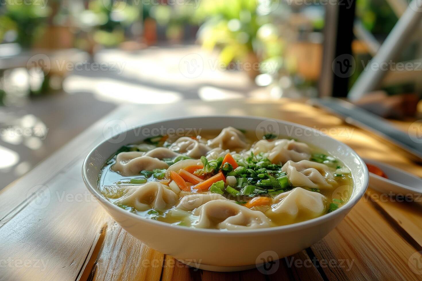 A bowl of soup with dumplings and vegetables photo