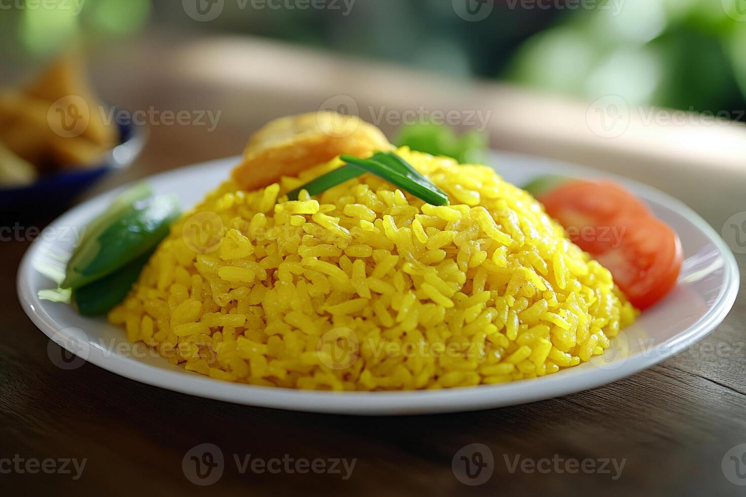 A plate of yellow rice with vegetables and a tomato photo