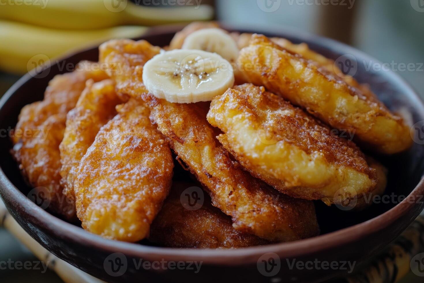 A bowl of fried chicken with bananas on top photo