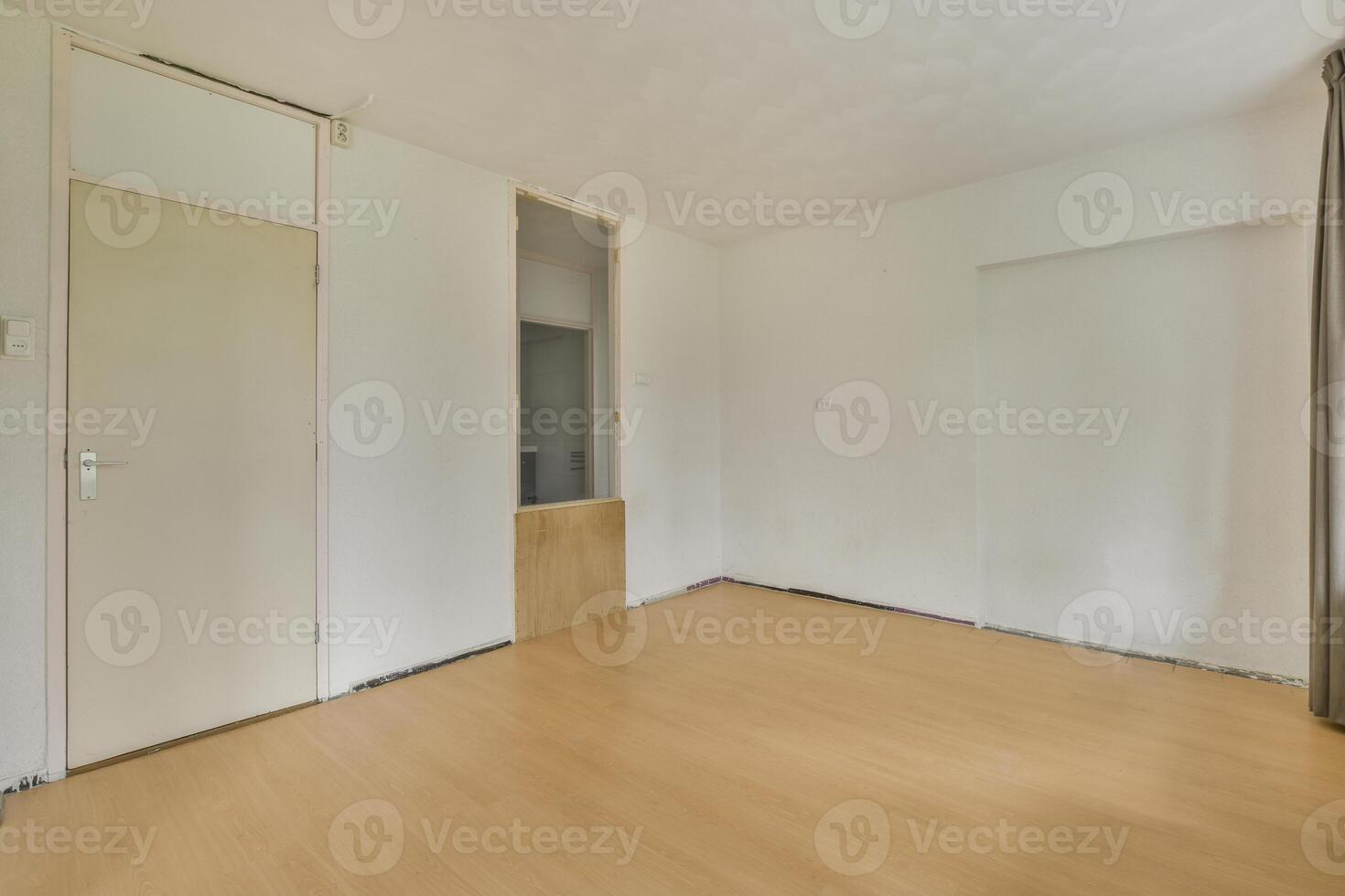 An empty room with wooden floors and a door photo