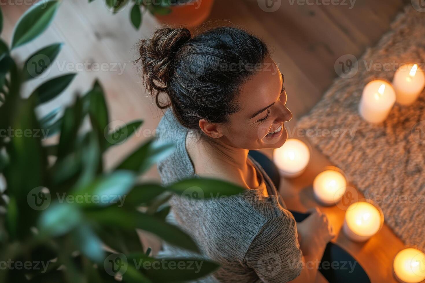 A woman is sitting on the floor with candles photo