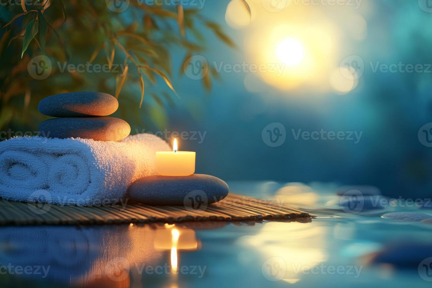 Spa stones and candles on bamboo mat with water photo