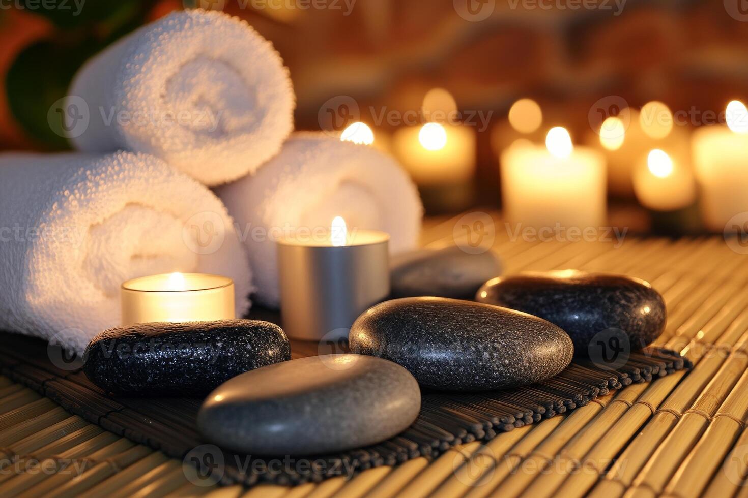 Spa stones and candles on a bamboo mat photo