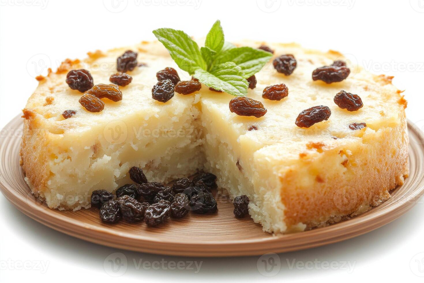 A cake with raisins and mint on a plate photo