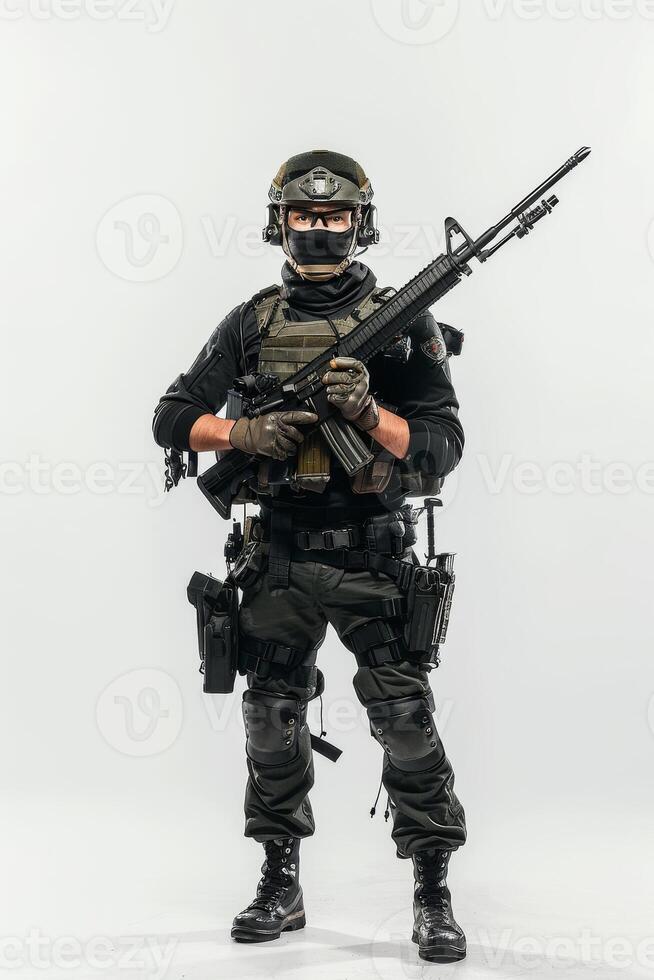 A man in military gear holding a rifle photo