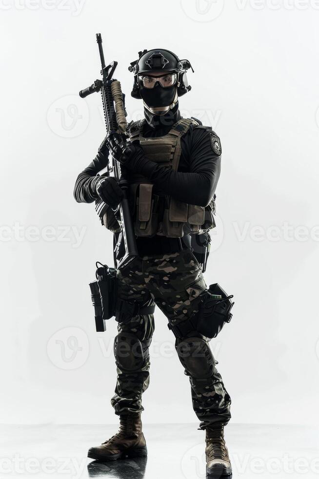 A man in camouflage gear holding a gun photo