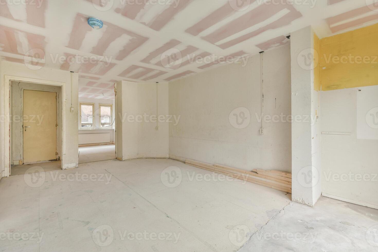 An empty room with yellow walls and a ceiling photo
