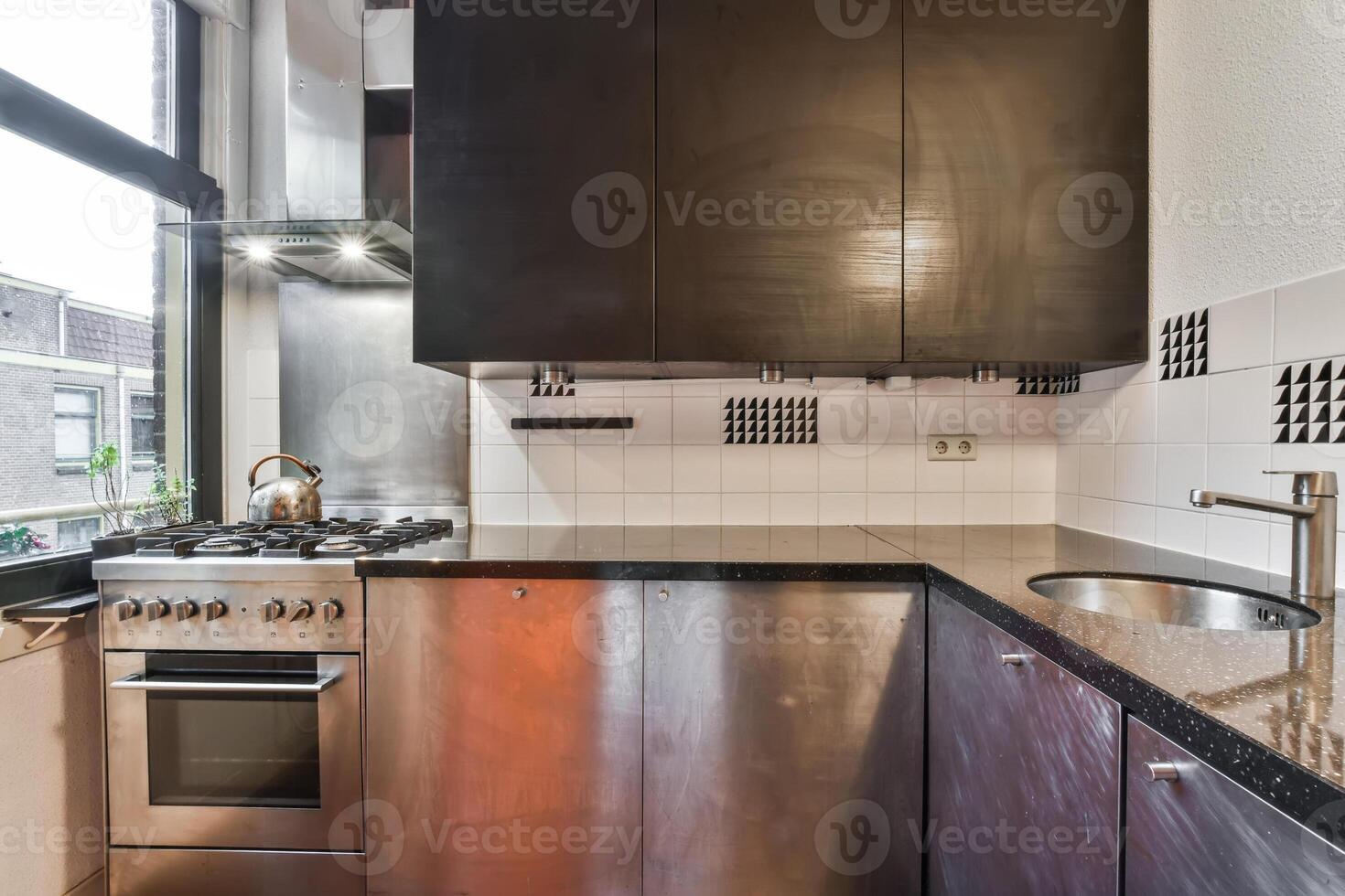 A kitchen with a sink and stove photo