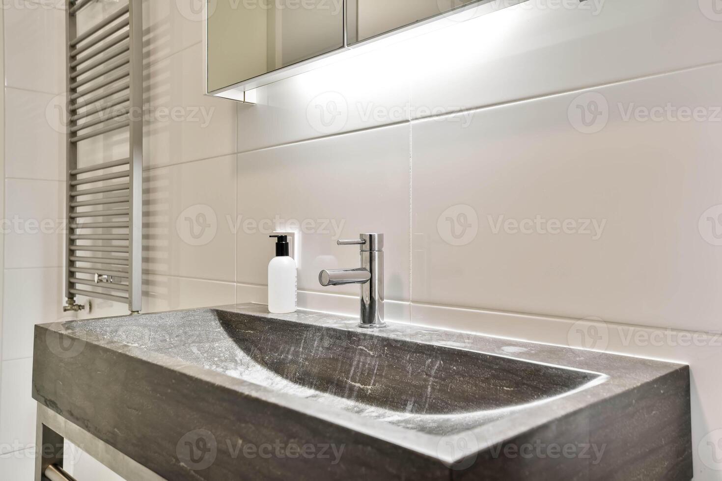 A bathroom with a sink and a mirror photo