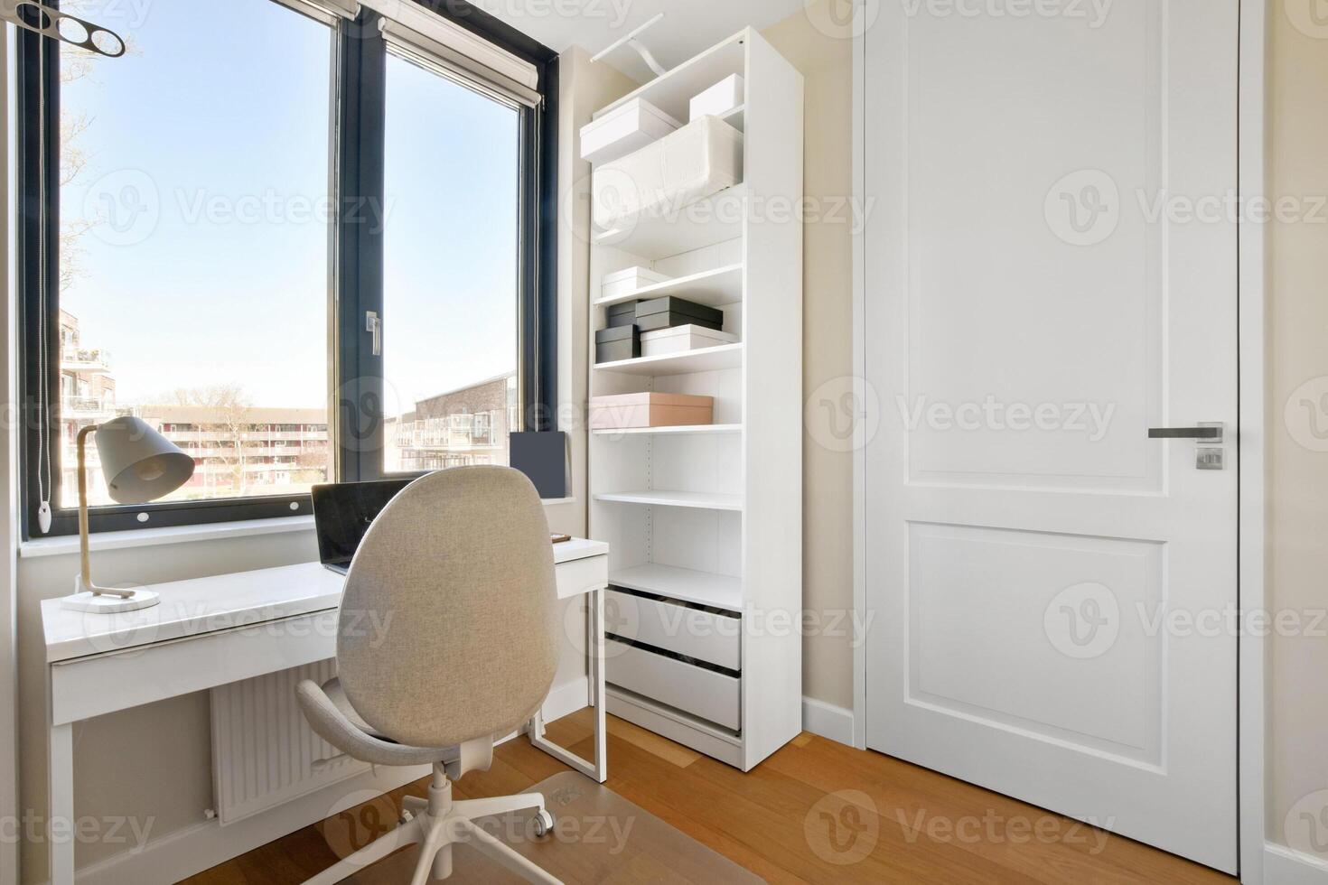 A white desk and chair in a small room photo