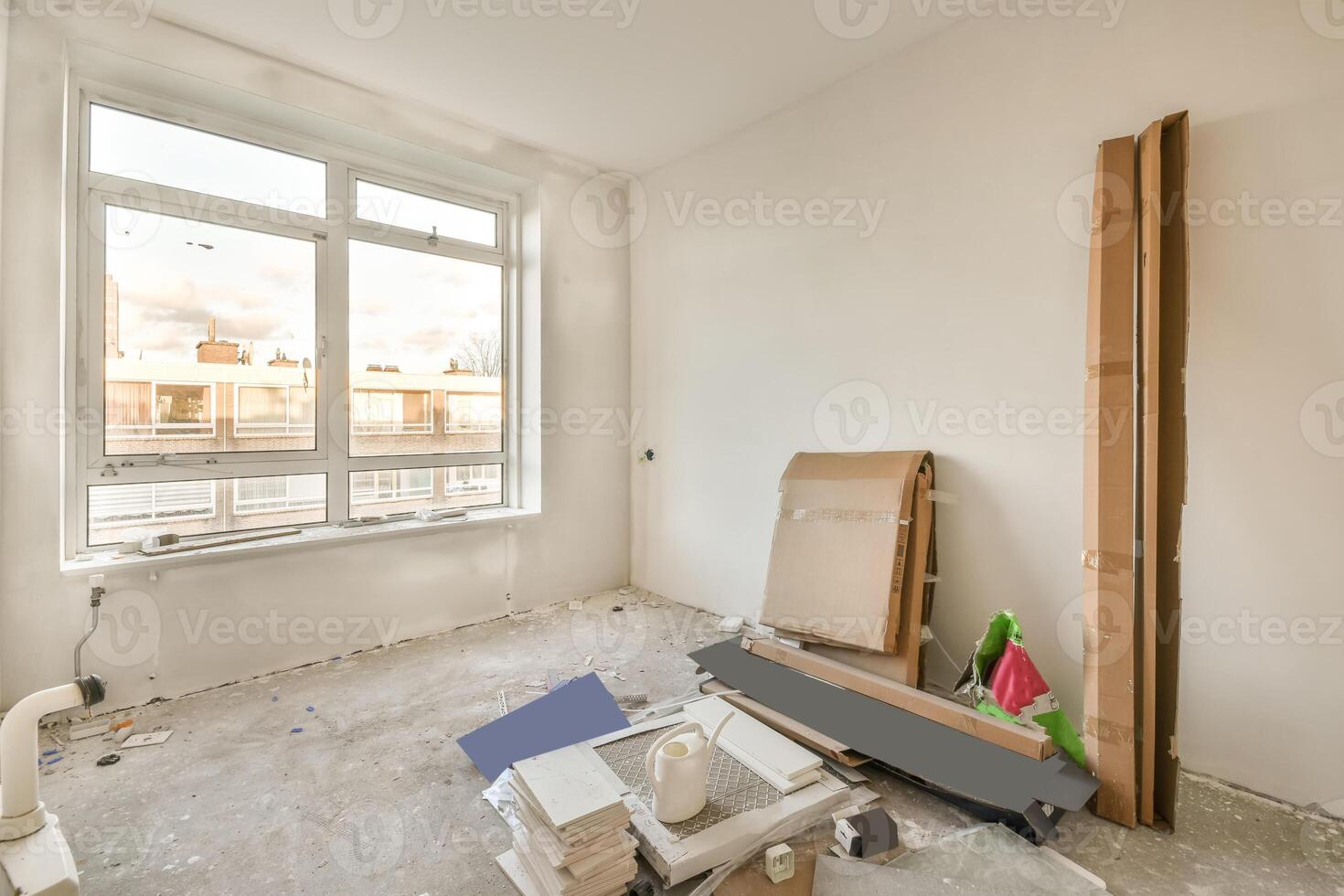 A room with a window and a lot of construction materials photo