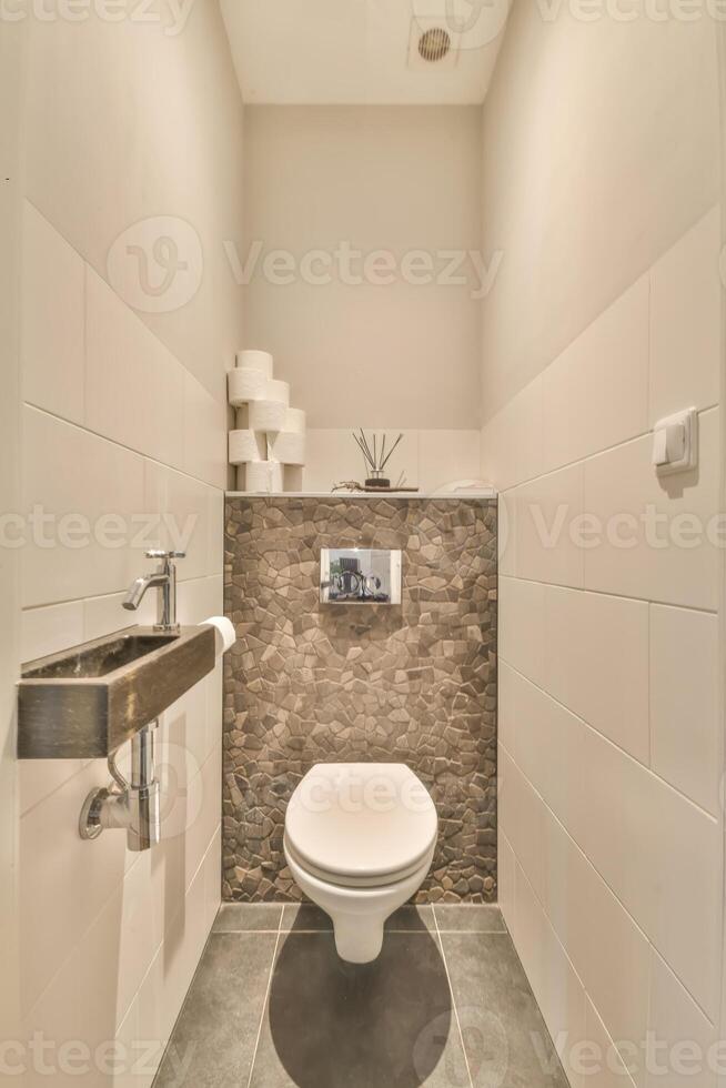 A bathroom with a toilet and a sink photo