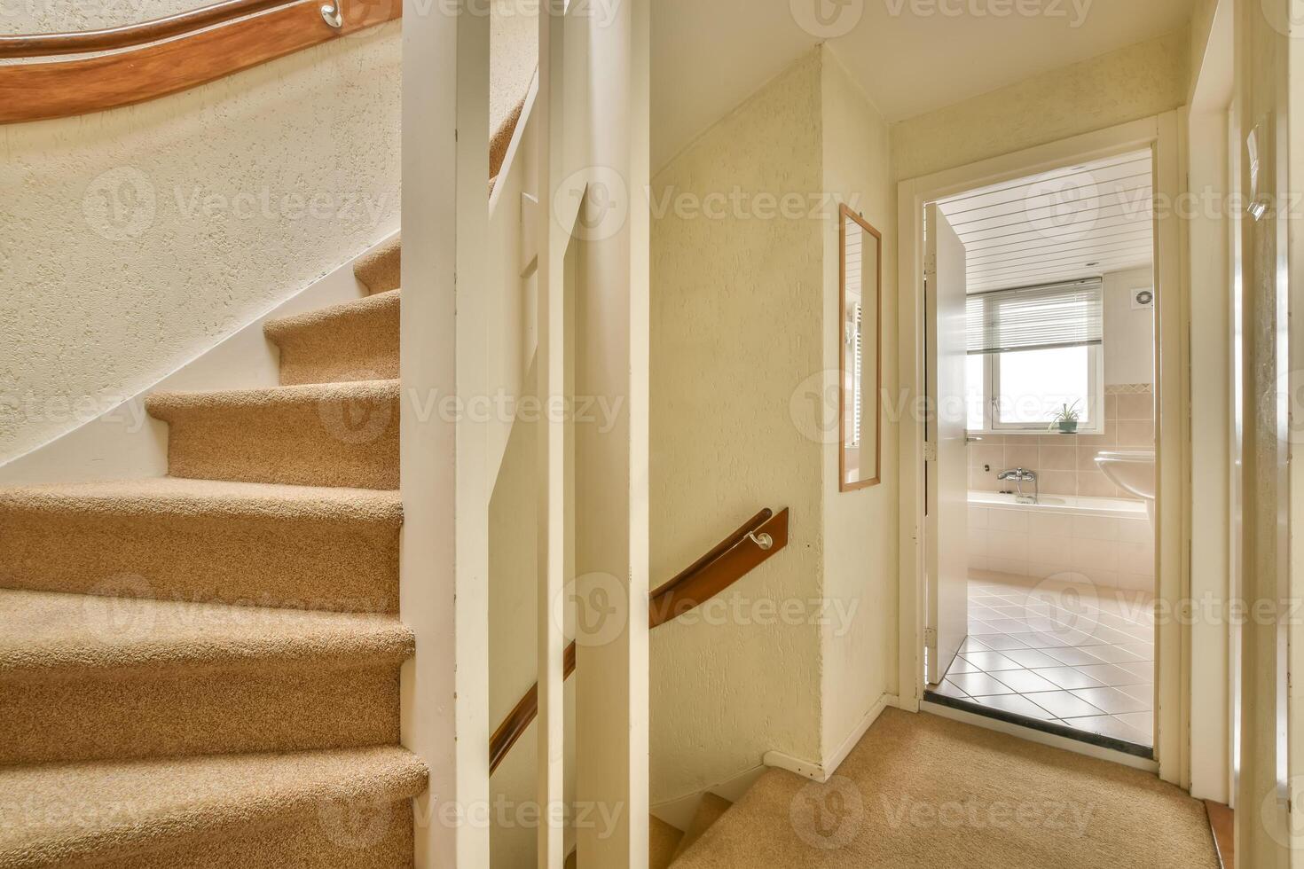 A stairway leading to a bathroom and a bathtub photo
